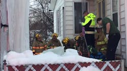 Erie, PA, firefighters chop through a massive chunk of ice that pinned a man's legs Monday as he was trying to dislodge it from a house. Erie, PA, firefighters chop through a massive chunk of ice that pinned a man's legs Monday as he was trying to dislodge it from a house.