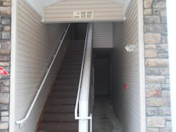 Photo 9: The first-arriving officer should practice 'tactical patience' when determining where to deploy the initial hoseline in multiple dwellings. The location of the address may be obscured by smoke, making deployment more difficult. Photo 9: The first-arriving officer should practice 'tactical patience' when determining where to deploy the initial hoseline in multiple dwellings. The location of the address may be obscured by smoke, making deployment more difficult.