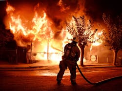 A Kern County firefighter puts water on a house fire near Taft, CA, in November 2017. A Kern County firefighter puts water on a house fire near Taft, CA, in November 2017.
