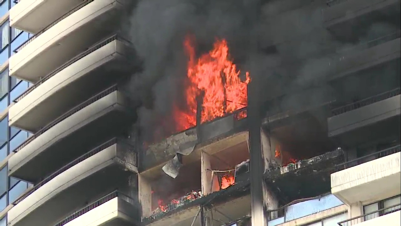 Fire rages on an upper floor of the Marco Polo residential high-rise in Honolulu on July 14, 2017.