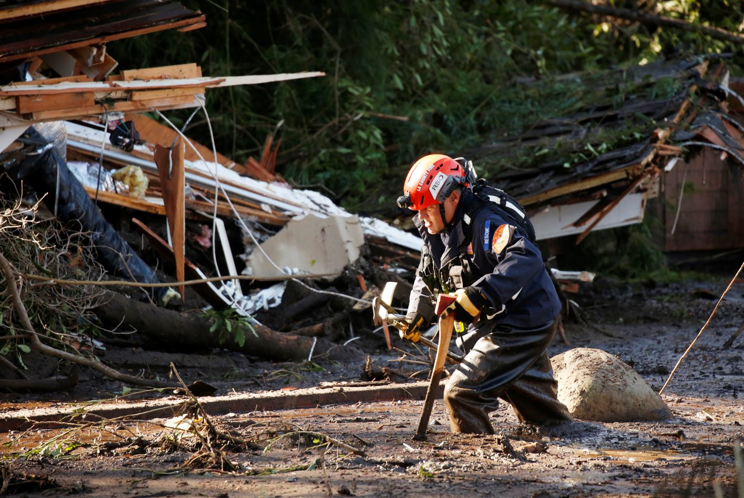 Crews from Orange County Search and Rescue work to locate victims along Olive Mill Road at Hot Springs Road in Montecito, CA, on Wednesday, Jan. 10, 2018.