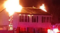 The home of Williamstown, NJ, firefighter Donna Parisi and her family burns on Sunday, Jan. 7, 2018.