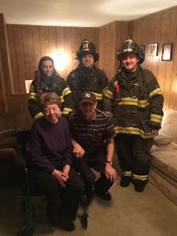 Fairmount firefighters pose with Richard Zera, 79, and Theresa Zera, 73, at their home in Camillus, NY.