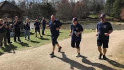 Asheville, NC, Division Chief Joy Ponder is flanked by two other firefighters as they approach the finish line of the Black Mountain Marathon on Saturday, Feb. 24, 2018. Asheville, NC, Division Chief Joy Ponder is flanked by two other firefighters as they approach the finish line of the Black Mountain Marathon on Saturday, Feb. 24, 2018.