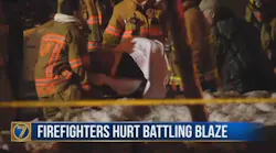 A Watertown, NY, firefighter is removed from the scene on a stretcher after being injured during a fire on Monday, Feb. 19. 2018.