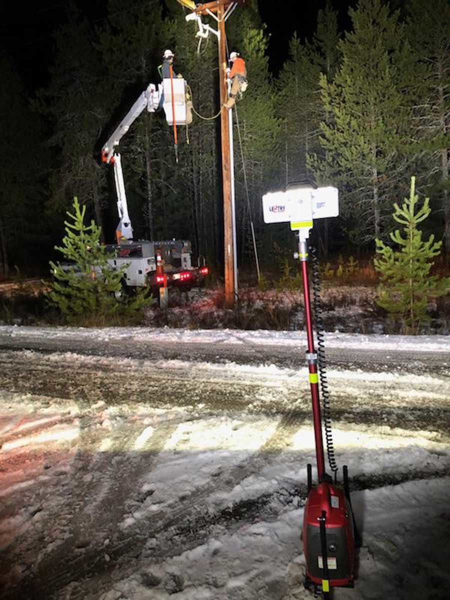 Pole work being safely and completely illuminated from across the road by one LENTRY LIGHT, model 1SPECX.