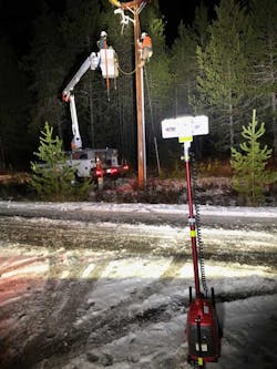 Pole work being safely and completely illuminated from across the road by one LENTRY LIGHT, model 1SPECX.