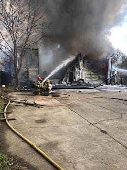 Crews battle a garage fire where a firefighter was trapped when a section of roof fell. Crews battle a garage fire where a firefighter was trapped when a section of roof fell.