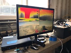 A monitor displays TIC and exterior cameras in a quad configuration. This image is broadcast to students in a classroom while an instructor explains what is happening. A monitor displays TIC and exterior cameras in a quad configuration. This image is broadcast to students in a classroom while an instructor explains what is happening.