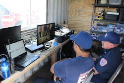 Instructors monitor the conditions of the training fire from the technology room. Instructors monitor the conditions of the training fire from the technology room.