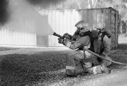 Firefighters applying gas cooling during training. The cone angle is approximately 60 degrees and is inclined 45 degrees with the ground. Firefighters applying gas cooling during training. The cone angle is approximately 60 degrees and is inclined 45 degrees with the ground.