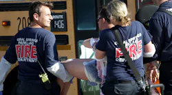 Medical personnel tend to a victim outside of Stoneman Douglas High School in Parkland, Fla., after a shooting on Wednesday, Feb. 14, 2018.