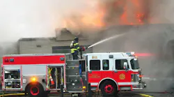 A Canandaigua, NY, firefighter pours water on a fire on Dec. 8, 2017.