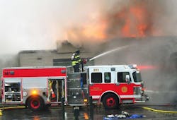 A Canandaigua, NY, firefighter pours water on a fire on Dec. 8, 2017. A Canandaigua, NY, firefighter pours water on a fire on Dec. 8, 2017.