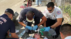 Captain Tony Milan, EMS Battalion Commander for City of Miami Fire Rescue, upper right, works on an overdose victim with his crew on Thusday, Nov. 17, 2017. The victim was suspected of a heroin/fentanyl overdose.
