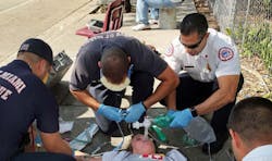 Captain Tony Milan, EMS Battalion Commander for City of Miami Fire Rescue, upper right, works on an overdose victim with his crew on Thusday, Nov. 17, 2017. The victim was suspected of a heroin/fentanyl overdose.