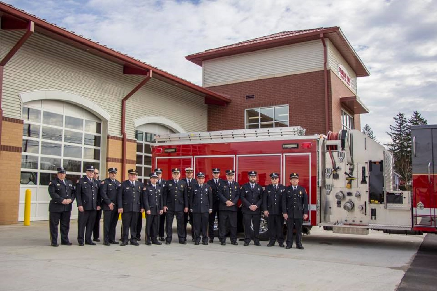 Franklin Park volunteer firefighters stand in front of their new station in Sewickley, PA, on Saturday, Feb. 17, 2018.