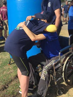 Asheville, NC, Division Chief Joy Ponder hugs terminally ill firefighter Will Willis after completing the Black Mountain Marathon in his honor on Saturday, Feb. 24, 2018. Asheville, NC, Division Chief Joy Ponder hugs terminally ill firefighter Will Willis after completing the Black Mountain Marathon in his honor on Saturday, Feb. 24, 2018.
