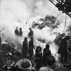 FDNY firefighters stand atop the rubble after a massive blaze at the Elkins Paper Company on Wooster St. in lower Manhattan killed two firefighters and four fire patrol officers on Feb. 14, 1958.