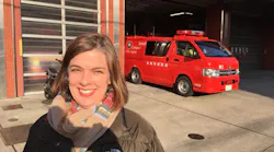 Syracuse, NY, District Fire Chief Sara Errington in front of a firehouse on a recent trip to Japan.