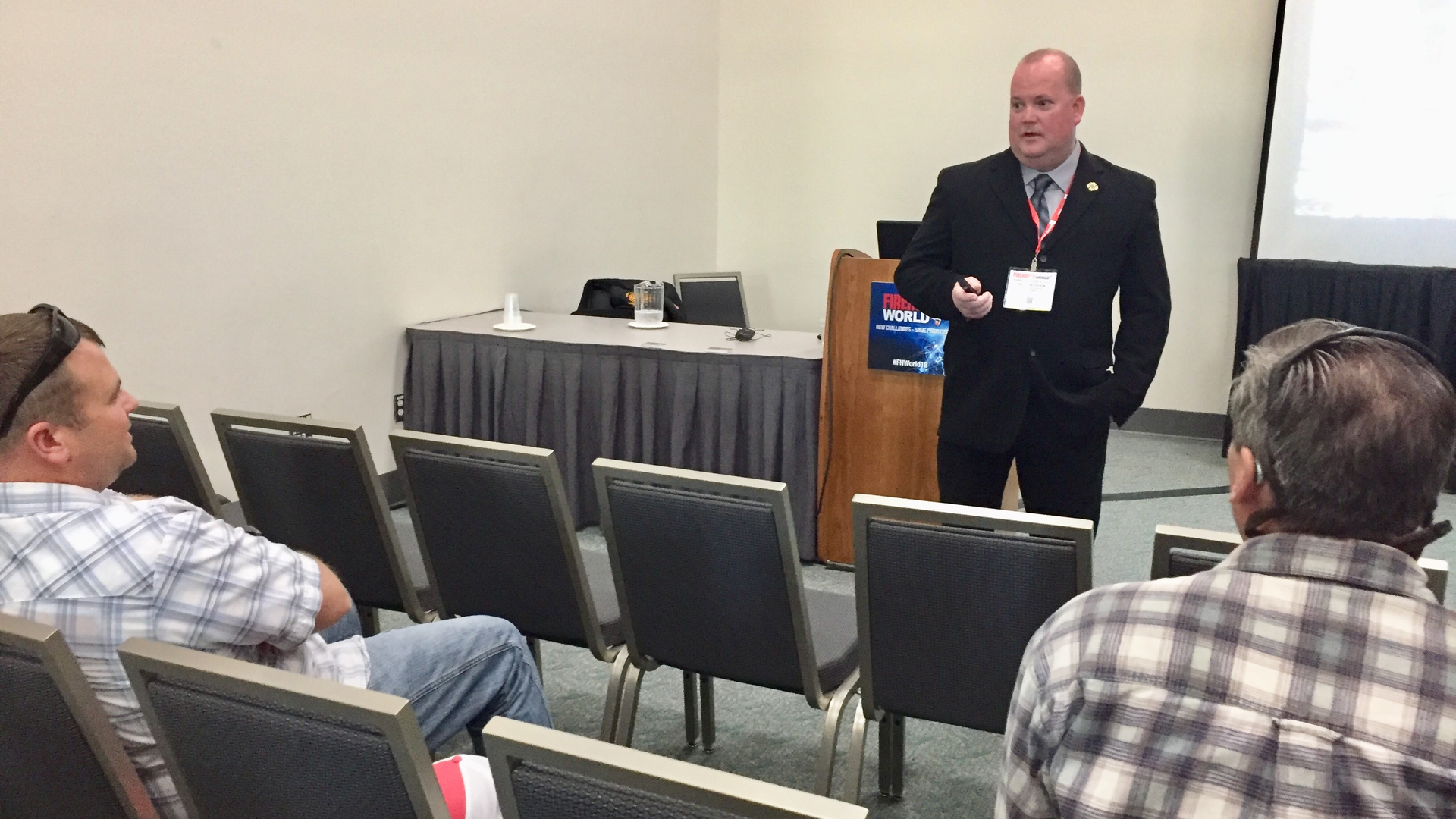 Scott Peterson talks with Firehouse World attendees during a break. Peterson said the fear of failing in front of firefighters dampens the motivation for training in the fire service.