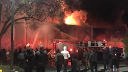 Bystanders look on as firefighters battle a deadly blaze at the Ghost Ship warehouse in Oakland, CA, on Dec. 2, 2016. Bystanders look on as firefighters battle a deadly blaze at the Ghost Ship warehouse in Oakland, CA, on Dec. 2, 2016.