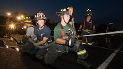 New City, NY, probationary firefighter Will McCue works a hose line during training.