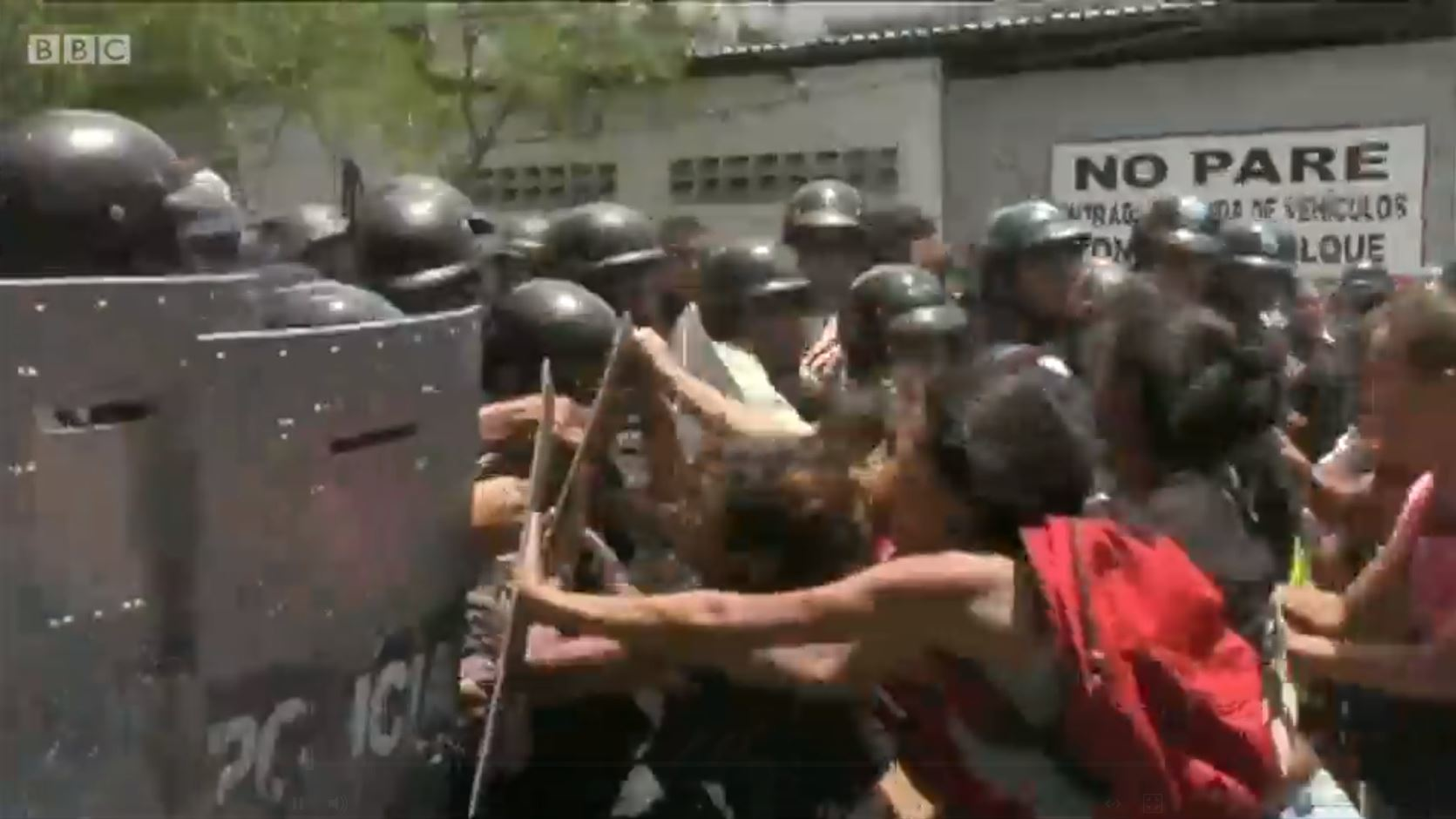 Relatives of detainees clash with police in Valencia, Venezuela, after they learned of a fire in a police station that killed at least 68 people on Wednesday, March 29, 2018.