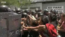 Relatives of detainees clash with police in Valencia, Venezuela, after they learned of a fire in a police station that killed at least 68 people on Wednesday, March 29, 2018.