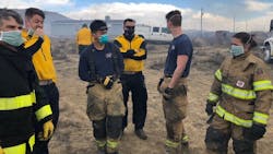 Fire crews wear breathing masks as they work near a contained tire fire in El Paso County, CO that continues to smolder and release hazardous materials. Fire crews wear breathing masks as they work near a contained tire fire in El Paso County, CO that continues to smolder and release hazardous materials.