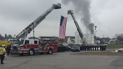 York, PA, area firefighters salute their fallen colleagues Ivan Flanscha and Zachary Anthony as smoke rises in the background after a house fire broke out during a memorial procession on Wednesday, March 28, 2018. York, PA, area firefighters salute their fallen colleagues Ivan Flanscha and Zachary Anthony as smoke rises in the background after a house fire broke out during a memorial procession on Wednesday, March 28, 2018.