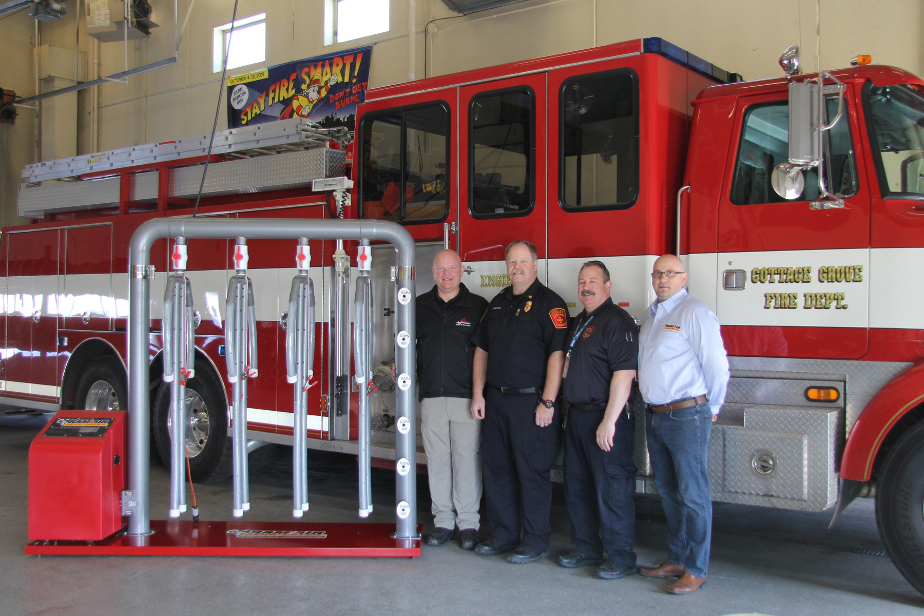 Cottage Grove Fire Department Fire Chief Rick Redenius (middle left) and and Cottage Grove Fire Department Deputy Fire Chief PJ McMahon (middle right) receive a Ram Air T4-MU Gear Dryer from Lance Dornn of Ram Air (far right) and Scott Bakos of Jefferson Fire (far left), Ram Air&rsquo;s authorized dealer for Minnesota. The gear dryer was awarded to the Cottage Grove Fire Department as part of Ram Air&rsquo;s 2017 Hometown Heroes Gear Dryer Giveaway.