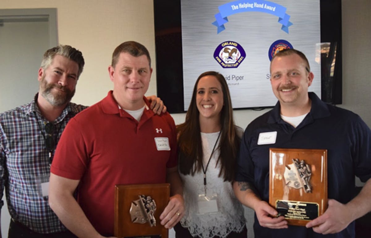 TargetSolutions&rsquo; Regional Sales Manager David Farrar, (left to right), Orland Fire Protection District&rsquo;s David Piper, TargetSolutions&rsquo; Account Manager Julie Blosch, and Manhattan Fire Department&rsquo;s Steve Malone gathered for a picture on March 6 during the Networking &amp; Training Workshop in San Diego. Piper and Malone were honored with the Helping Hand Award, given each year to a person or persons who go above and beyond to assist other agencies with fire department training.