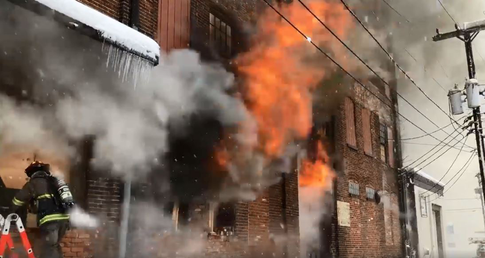 A firefighter works at the scene of the piano warehouse fire Wednesday.