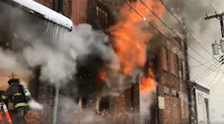 A firefighter works at the scene of the piano warehouse fire Wednesday.