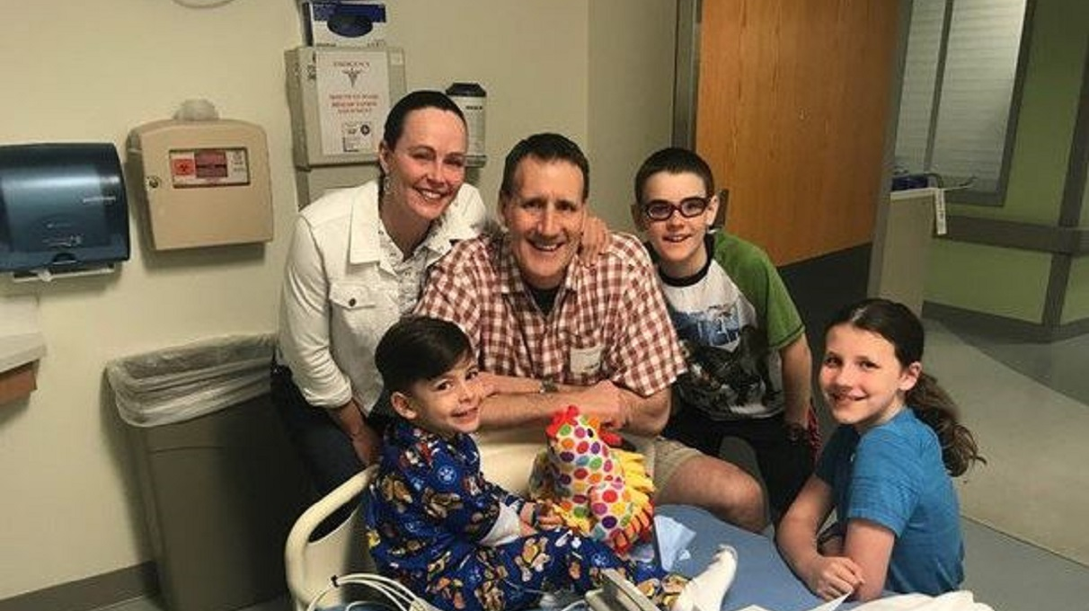 Retired Hoover, AL, Fire Capt. Keith Jacobson, his wife Dr. Elizabeth Jacobson and their two children Sam and Sarah Claire visit a young boy who nearly drowned in a hotel pool on Saturday, April 28, 2018.