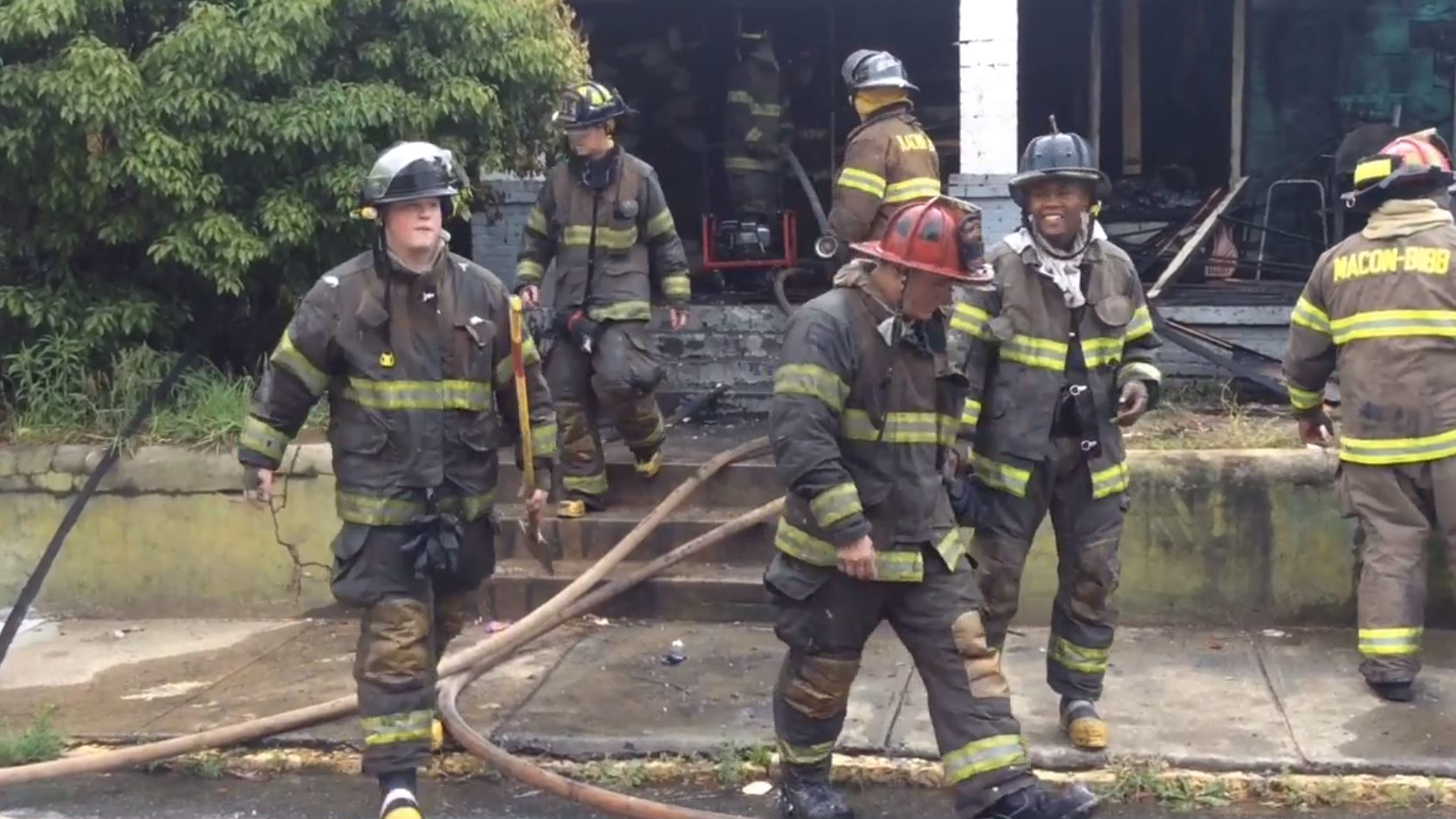 Macon-Bibb County firefighters at the scene of a house fire in Macon, GA, on Friday, April 27, 2018.