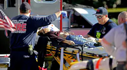 Medical personnel tend to a victim outside Marjory Stoneman Douglas High School in Parkland, FL, during a mass shooting that claimed 17 lives on Feb. 14, 2018.
