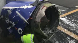 Workers inspect the engine compartment on a Southwest Airlines plane after an explosion forced an emergency landing at Philadelphia International Airport on Tuesday, April 17, 2018.