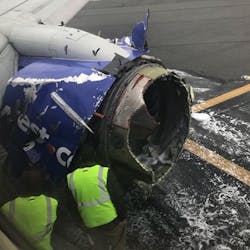 Workers inspect the engine compartment on a Southwest Airlines plane after an explosion forced an emergency landing at Philadelphia International Airport on Tuesday, April 17, 2018.