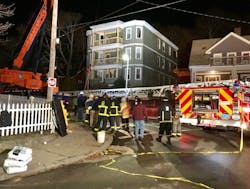 Boston fire officials look over the aerial after a crane removed the aerial ladder off the roof of the building. Boston fire officials look over the aerial after a crane removed the aerial ladder off the roof of the building.