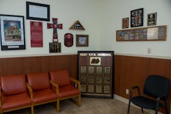 Two walls in the meeting and training room at the West fire station are adorned with memorials.
