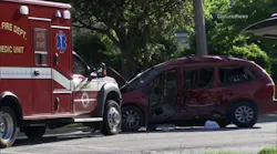 A badly damaged minivan sits in front of a fire department ambulance after the two vehicles were involved in a wreck in Aurora, IL, on Wednesday, May 16, 2018.