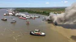 Smoke rises from a barge burning on the Mobile River on Sunday, May 6, 2018.