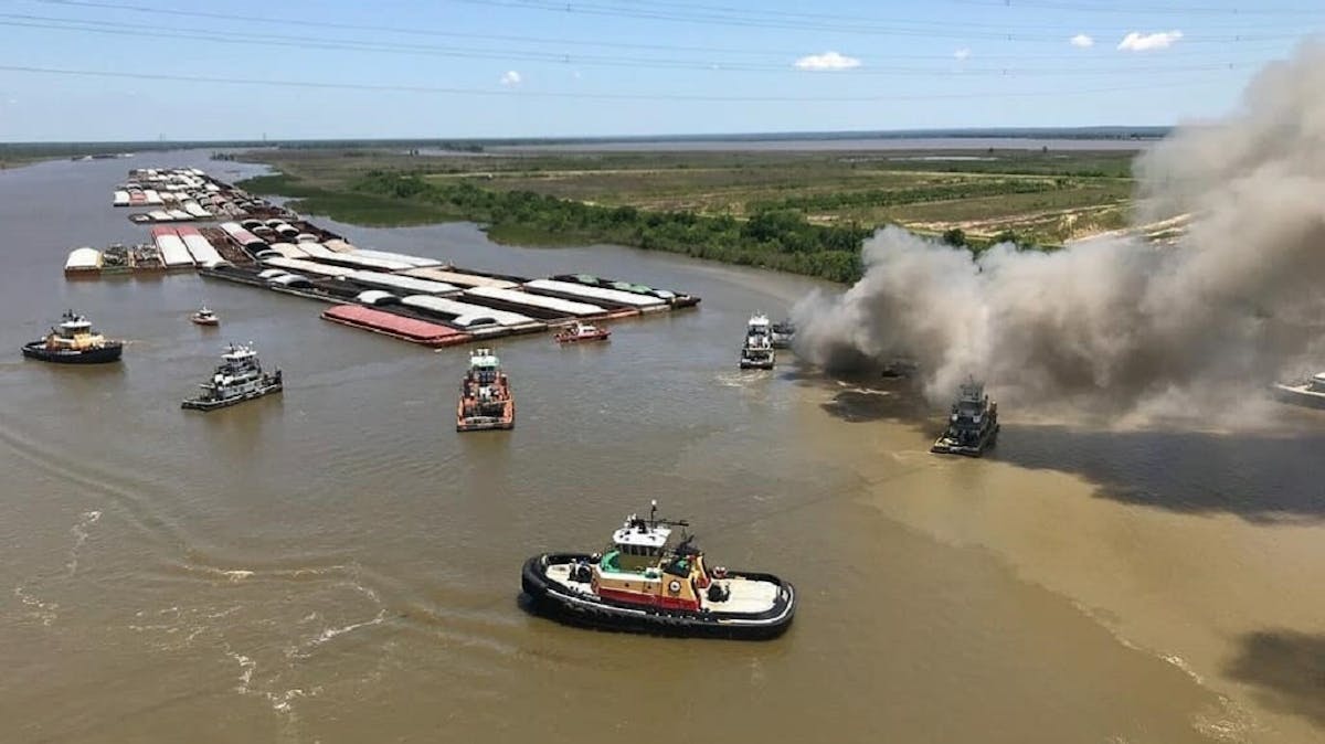 Smoke rises from a barge burning on the Mobile River on Sunday, May 6, 2018.