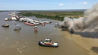Smoke rises from a barge burning on the Mobile River on Sunday, May 6, 2018.