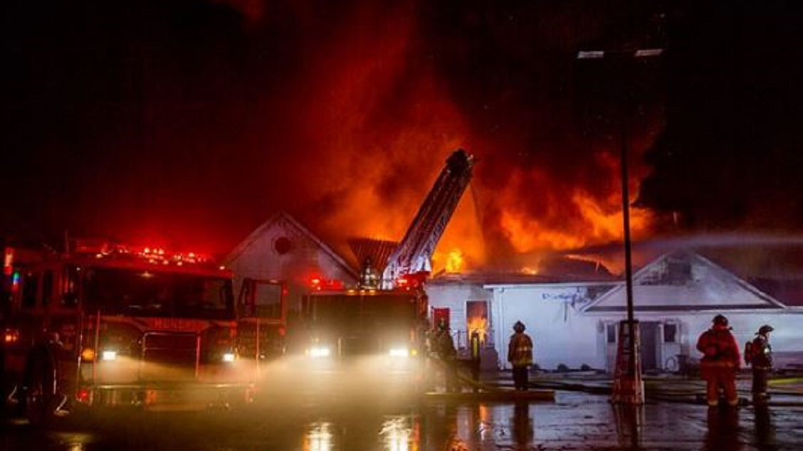 The Sharp Funeral Home in Swartz Creek, MI, burns while firefighters tackle the flames on Wednesday, May 16, 2018.