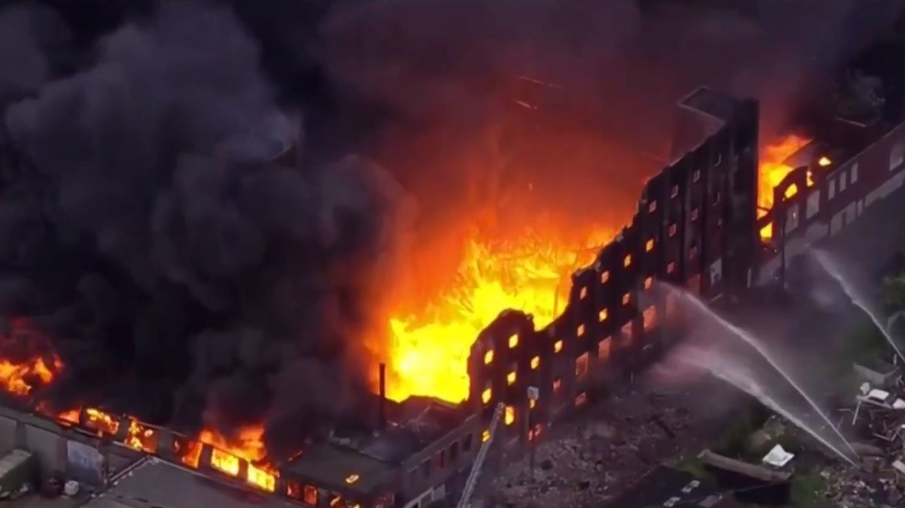 A massive five-alarm fire consumes an unoccupied warehouse in North Philadelphia on Friday, May 18, 2018.