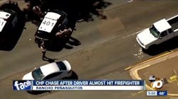 California Highway Patrol officers take a man into custody suspected of sparking a brush fire and nearly running over a firefighter in the San Diego area on Monday, May 28, 2018.