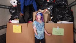 Fire survivor Safyre Terry, 10, stands in a tractor trailer full of gifts she received after a Facebook post asking for Christmas cards went viral in 2015.
